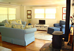 Manchester rental living area with woodstove